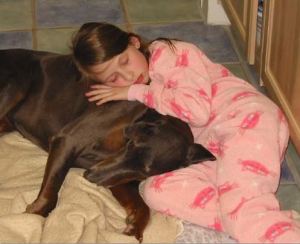 Emma pretending to sleep on the kitchen floor with our dog, Jinxy.  Emma Roey, Emma Kate Roey, Emma Katherine Roey